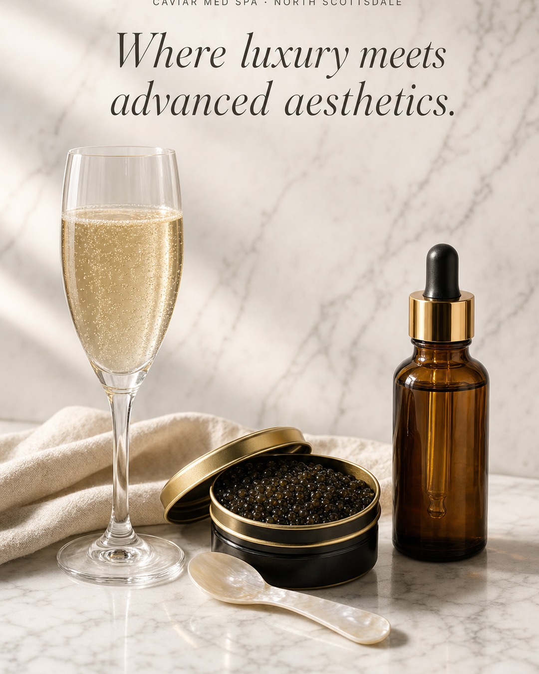 Caviar Med Spa — champagne, caviar, and serum on Carrara marble